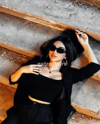 call girl noida laying on stair in black dress